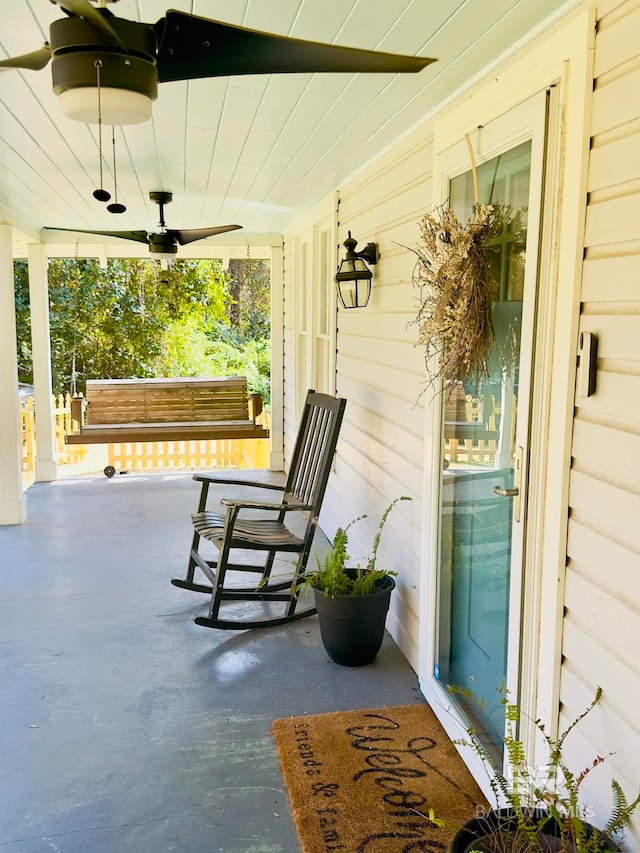 view of patio / terrace with ceiling fan and a porch