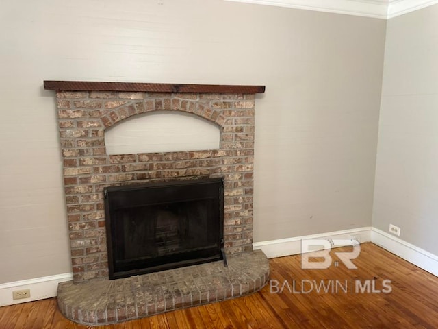 interior details featuring ornamental molding, a fireplace, and wood-type flooring