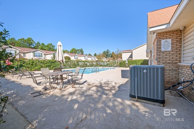 view of swimming pool with a patio area and central AC unit