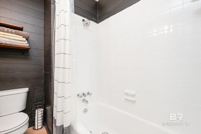 bathroom featuring wooden walls, toilet, and shower / bath combo