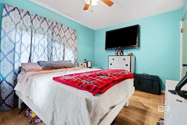 bedroom with hardwood / wood-style flooring and ceiling fan