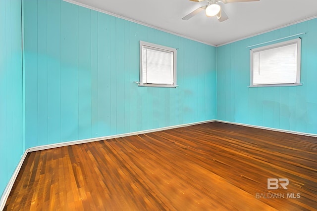 empty room featuring ornamental molding, hardwood / wood-style floors, and ceiling fan