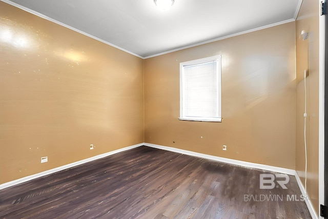 empty room featuring dark hardwood / wood-style flooring and ornamental molding