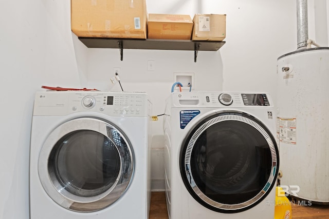 laundry room with gas water heater and washer and dryer