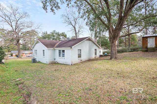 exterior space with a yard and central air condition unit