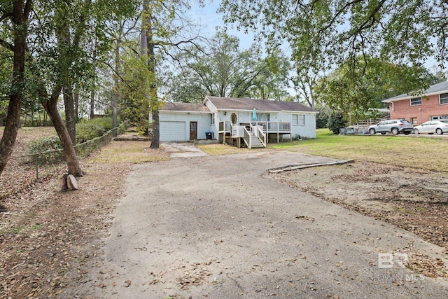 view of front of house with a garage and a front lawn