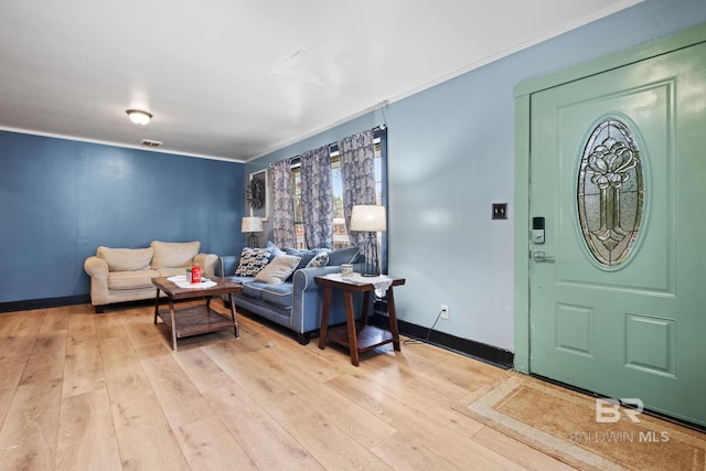 living room with crown molding and light wood-type flooring