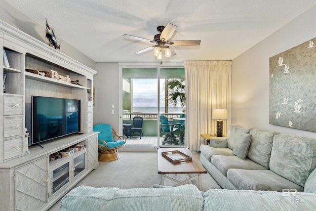 living room featuring ceiling fan and carpet floors