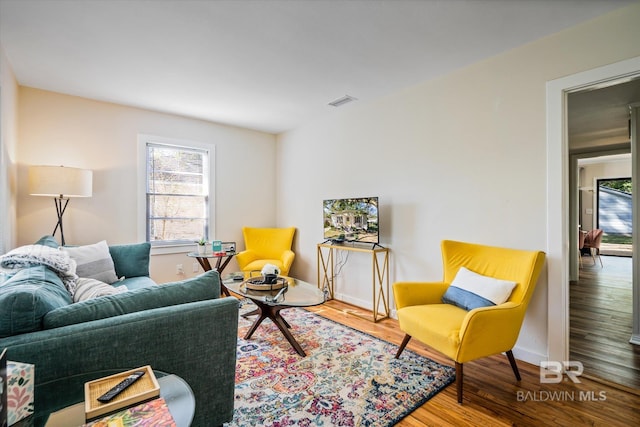 54 S Bishop Ln, Mobile, AL 36608 - living area with healthy amount of natural light, wood finished floors, and baseboards