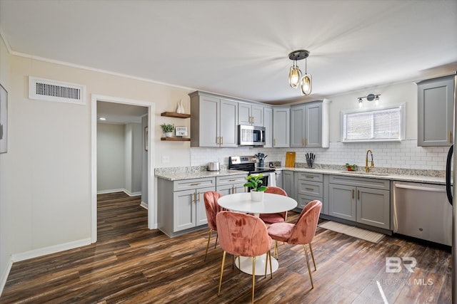 54 S Bishop Ln, Mobile, AL 36608 - kitchen with gray cabinetry, stainless steel appliances, a sink, dark wood-style floors, and crown molding