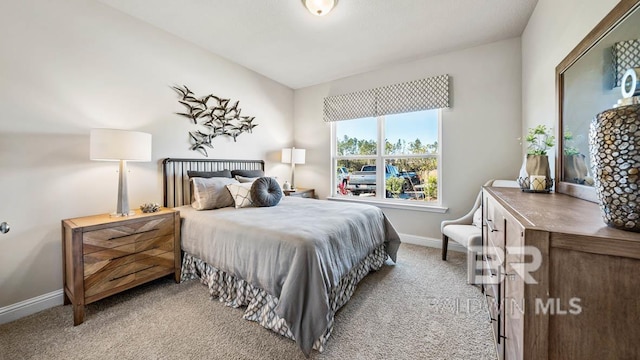 carpeted bedroom featuring baseboards