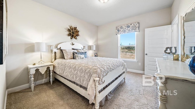 bedroom featuring carpet flooring and baseboards