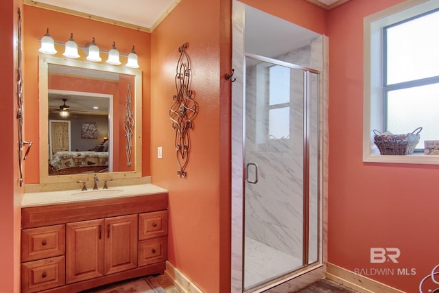 bathroom featuring vanity, ceiling fan, and an enclosed shower