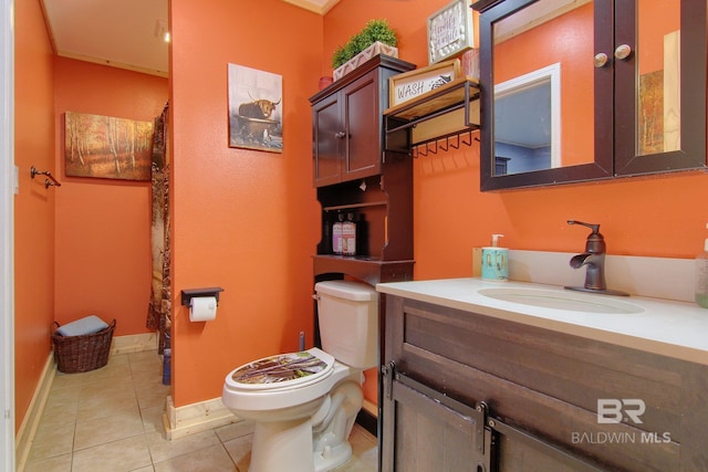 bathroom featuring vanity, toilet, and tile patterned floors