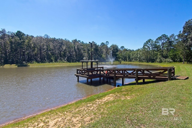 view of dock with a water view and a lawn