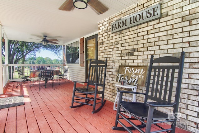 wooden deck featuring covered porch and ceiling fan