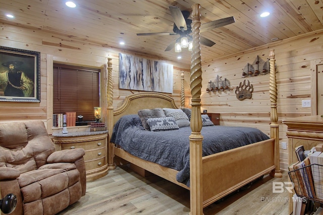 bedroom featuring ceiling fan, wood walls, wooden ceiling, and light wood-type flooring