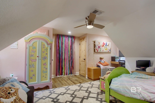 bedroom with vaulted ceiling, light wood-type flooring, and ceiling fan