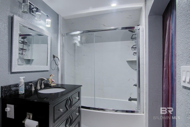 bathroom with vanity and shower / bath combination with glass door