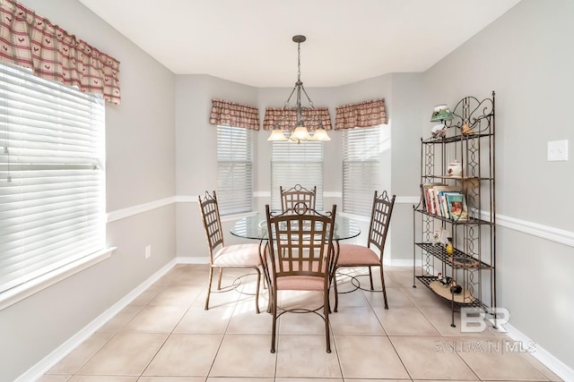 dining room with light tile patterned floors and a notable chandelier