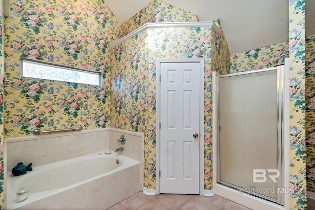 bathroom with tile patterned floors, separate shower and tub, and lofted ceiling