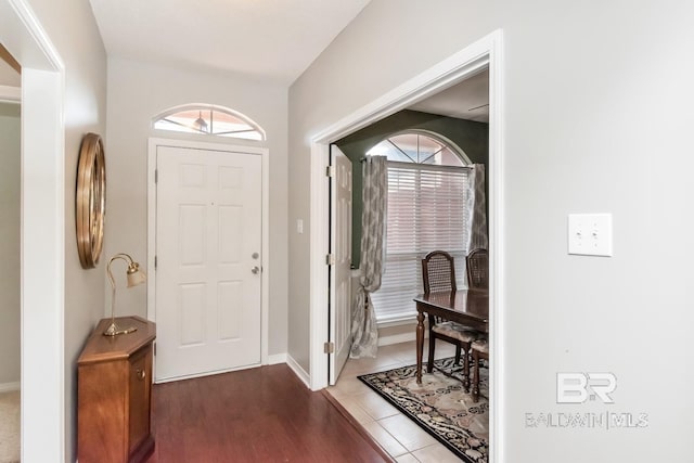 tiled entrance foyer featuring a healthy amount of sunlight