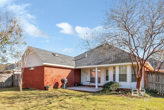 rear view of house featuring a patio and a lawn