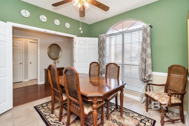 dining space with ceiling fan and light tile patterned floors