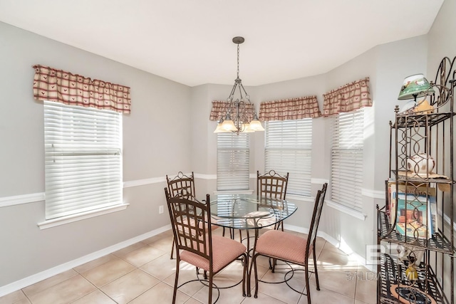 dining space featuring a chandelier, a healthy amount of sunlight, and light tile patterned flooring