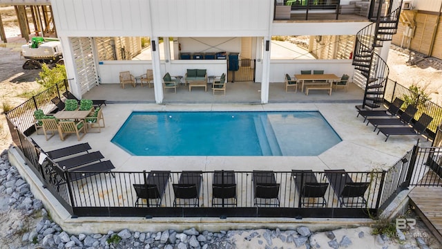 pool featuring fence, stairs, an outdoor hangout area, and a patio area