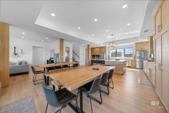 dining space with stairs, recessed lighting, and light wood finished floors
