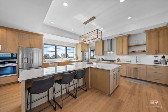 kitchen with open shelves, stainless steel appliances, a kitchen island, light wood-style floors, and wall chimney exhaust hood