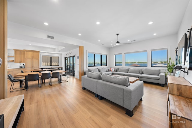 living room featuring light wood finished floors, recessed lighting, and a ceiling fan
