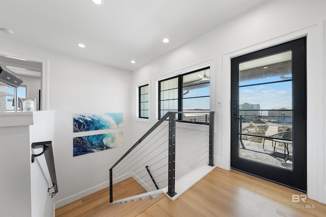 interior space featuring recessed lighting, baseboards, and wood finished floors