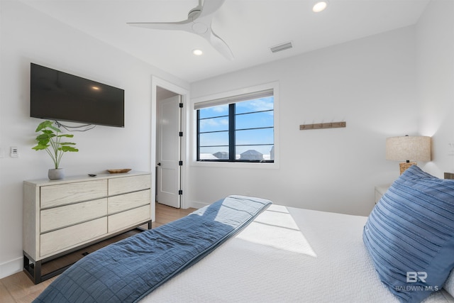 bedroom featuring baseboards, visible vents, wood finished floors, and recessed lighting