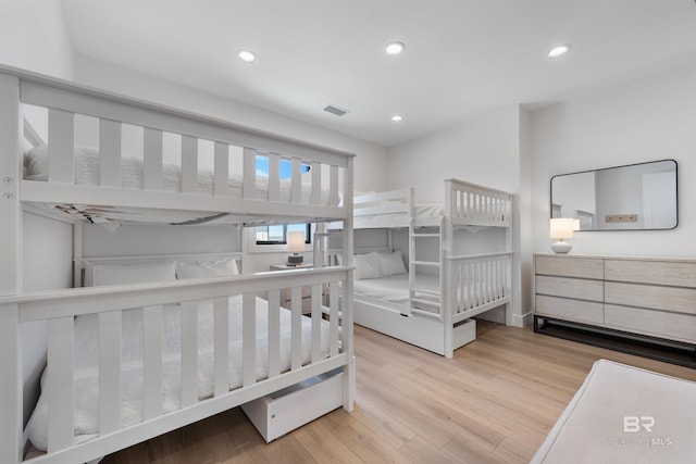 bedroom with visible vents, wood finished floors, and recessed lighting