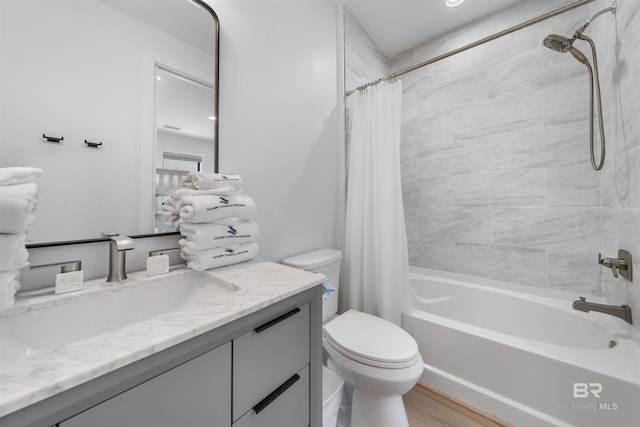 bathroom with toilet, shower / bath combination with curtain, vanity, and wood finished floors