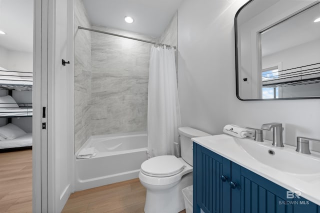 bathroom with vanity, recessed lighting, toilet, shower / bath combo, and wood finished floors