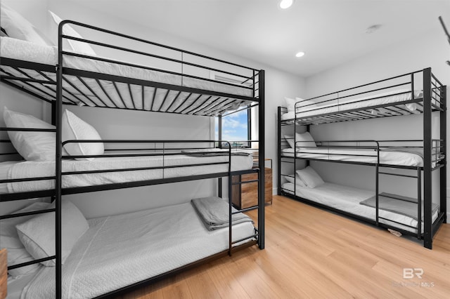 bedroom with recessed lighting and wood finished floors