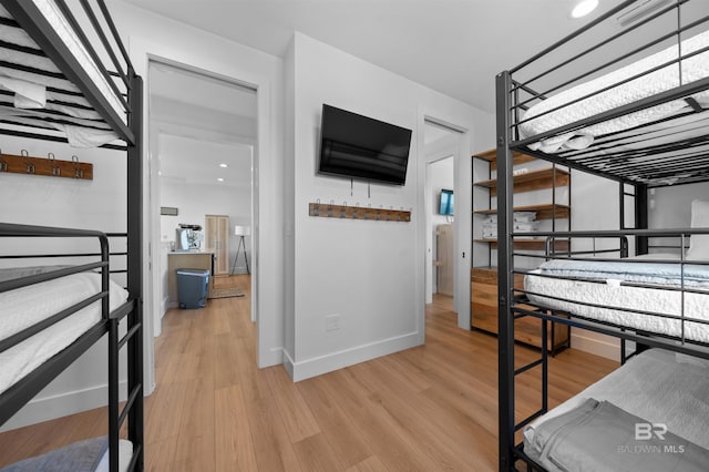 bedroom featuring baseboards and light wood-type flooring