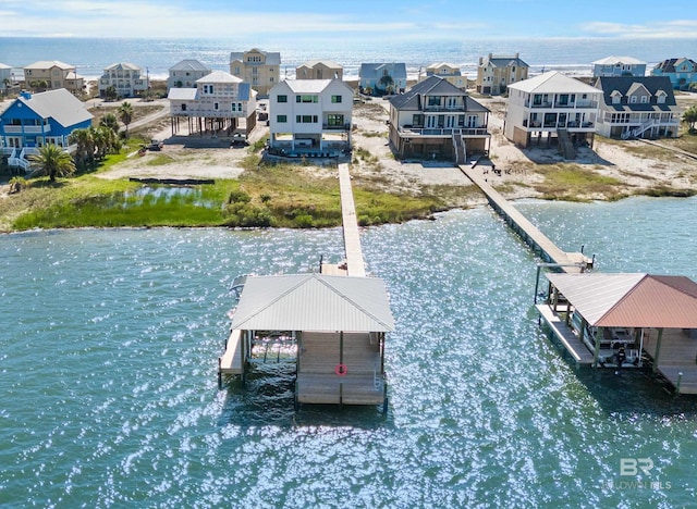 view of dock with a residential view and a water view