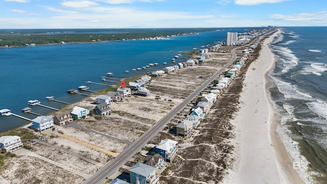 drone / aerial view featuring a water view and a view of the beach
