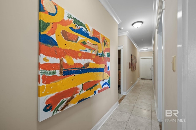 hall featuring ornamental molding, tile patterned flooring, and baseboards