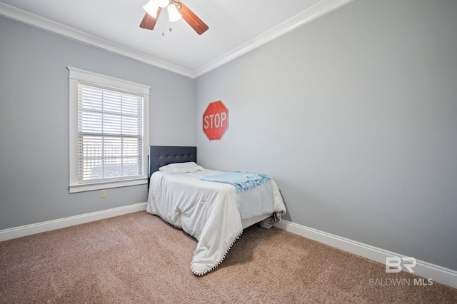 carpeted bedroom with ceiling fan, ornamental molding, and baseboards