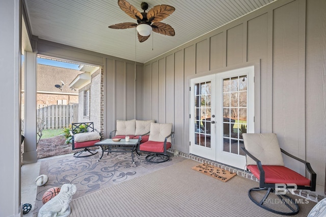 sunroom with a ceiling fan and french doors