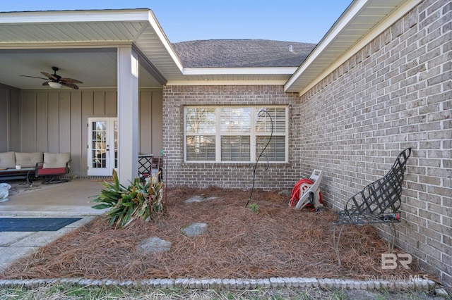 entrance to property featuring a ceiling fan, an outdoor hangout area, french doors, a patio area, and brick siding