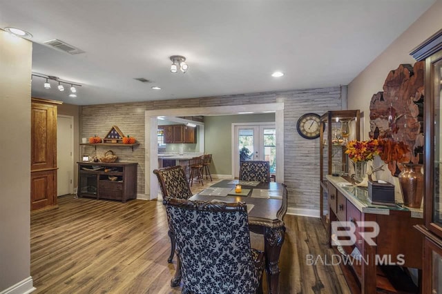 dining area featuring dark wood-type flooring and french doors