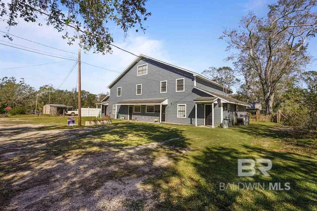 rear view of house with a lawn