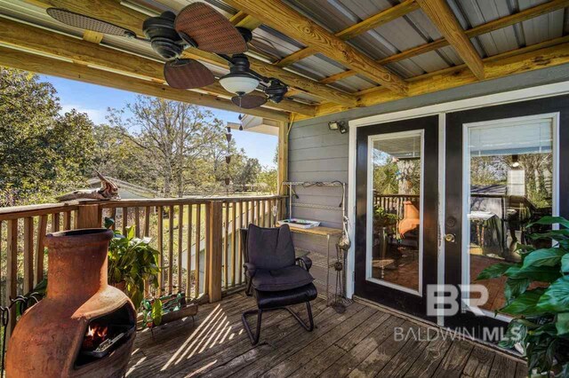 wooden terrace featuring ceiling fan