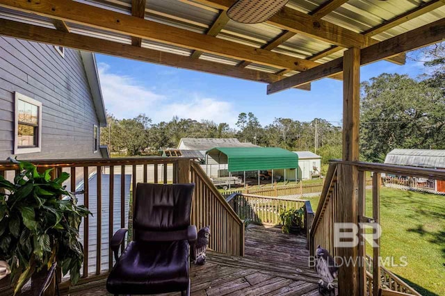 deck with ceiling fan and a yard